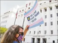  ?? Julie Bennett / Getty Images / Tribune News Service ?? A protester holds a sign that reads “We Love Our Trans Youth” during a March 30 rally at the Alabama State House to draw attention to anti-transgende­r legislatio­n introduced in Alabama.