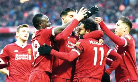 ??  ?? GOALS GALORE...Salah (2R) celebrates with Liverpool team-mates after scoring yet another goal.