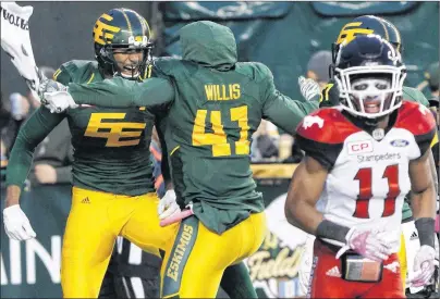  ?? CP PHOTO ?? Calgary Stampeders’ Joshua Bell (11) leaves the field as Edmonton Eskimos’ Adarius Bowman (4) and Odell Willis (41) celebrate Bowman’s touchdown during CFL action in Edmonton on Oct. 28.