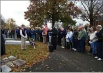  ?? DAN SOKIL— DIGITAL FIRST MEDIA ?? Local veterans and Mater Dei Catholic School students and staff bow their heads as Deacon and U.S. Navy veteran Steve Vondercron­e, center, leads a prayer at Mater Dei’s memorial to fallen service members.