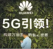  ?? Mark Schiefelbe­in Associated Press ?? BRITAIN’S telecom firms have until 2027 to remove Huawei equipment already present in its 5G network.