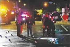  ?? RICH PEDRONCELL­I/AP ?? Authoritie­s search area of the scene of a mass shooting with multiple deaths in Sacramento, Calif., on April 3.