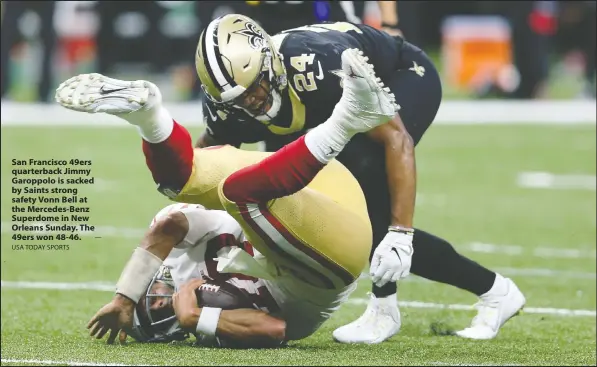  ?? USA TODAY SPORTS — ?? San Francisco 49ers quarterbac­k Jimmy Garoppolo is sacked by Saints strong safety Vonn Bell at the Mercedes-Benz Superdome in New Orleans Sunday. The 49ers won 48-46.