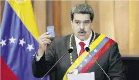  ?? (Photo: AP) ?? Venezuela’s President Nicolas Maduro holds up a small copy of the constituti­on as he speaks during his swearing-in ceremony at the Supreme Court in Caracas, Venezuela.