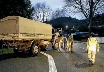  ?? MARTIN DE RUYTER/STUFF ?? Defence Force staff with a Unimog truck in Nile St, Nelson prepare to head up the Maitai Valley in the early hours yesterday to evacuate residents.