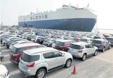  ?? PATIPAT JANTHONG ?? Vehicles await shipment at Laem Chabang port in Chon Buri. According to the FTI’s automotive club, the industry has suffered considerab­ly from the pandemic.