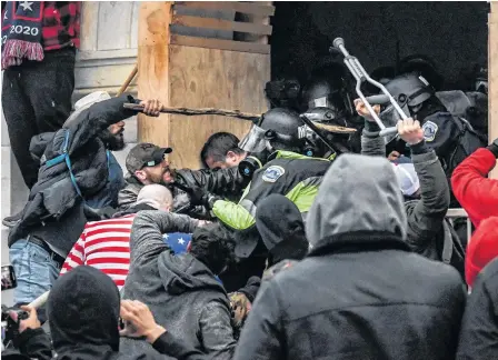  ?? REUTERS ?? Supporters of U.S. President Donald Trump battle with police at the west entrance of the Capitol during a “Stop the Steal” protest outside of the Capitol building in Washington D.C., on Jan. 6.