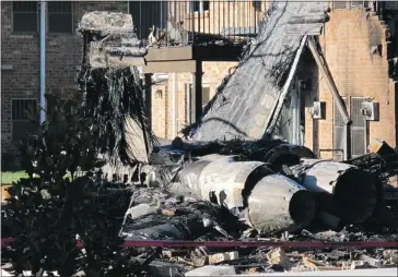  ?? David Zucchino, Los Angeles Times ?? The tail section of a U.S. navy F/A-18D Hornet sits amid wrecked buildings in Virginia Beach, Va., on Saturday.