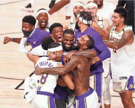  ?? KIM KLEMENT/USA TODAY SPORTS ?? The Lakers celebrate the franchise’s record-tying 17th NBA title after defeating the Heat 106-93 in Game 6 of the Finals on Sunday night.