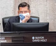  ?? CHRIS LANDSBERGE­R/THE OKLAHOMAN ?? Mayor David Holt wore a mask as he listened during an Oklahoma City Council meeting on Aug. 3.