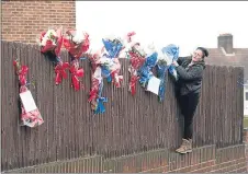  ??  ?? Flowers have been placed opposite the Brooks’ home