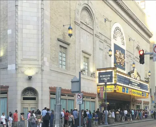  ?? Catherine Cray/Post-Gazette ?? Theatergoe­rs wait to get into the Benedum Center, Downtown, for “In the Heights” earlier this month.