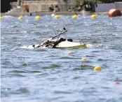  ?? ANDRE PENNER/ASSOCIATED PRESS ?? Rowers Milos Vasic and Nenad Bedik of Serbia capsize into polluted water during the men's pair heat.