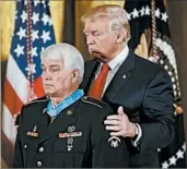  ?? PABLO MARTINEZ MONSIVAIS/AP ?? President Donald Trump bestows the Medal of Honor on retired Army medic James McCloughan on Monday.