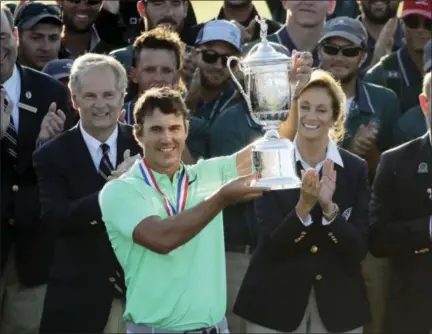  ?? CHARLIE RIEDEL — THE ASSOCIATED PRESS ?? Brooks Koepka holds up the trophy after winning the U.S. Open Sunday at Erin Hills in Erin, Wis.