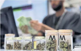  ?? JOHN LOCHER THE ASSOCIATED PRESS FILE PHOTO ?? Private cannabis stores will have to give up offering delivery and curbside pickup, which helped generate more business during the pandemic, despite a likely extension of emergency orders