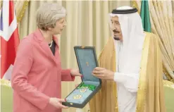  ??  ?? RIYADH: Saudi King Salman bin Abdulaziz presents British Prime Minister Theresa May with the Order of King Abdulaziz yesterday.