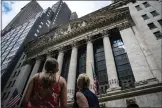  ?? JOHN MINCHILLO-ASSOCIATED PRESS ?? Pedestrian­s pass the New York Stock Exchange on July 14, 2022, in New York.