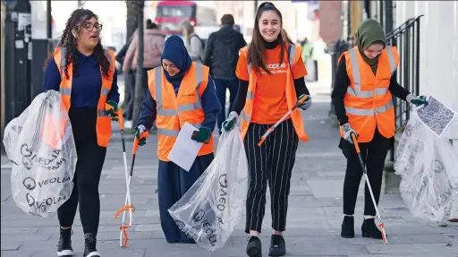  ?? ?? Doing their bit: Four volunteers join a litter-picking event in East London as hundreds get involved across the nation