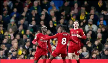  ?? Photo/Frank Augstein AP ?? Liverpool’s Sadio Mane (left) celebrates with teammates after scoring his side’s opening goal during the English Premier League soccer match between Norwich City and Liverpool at Carrow Road Stadium in Norwich, England, on Saturday.
