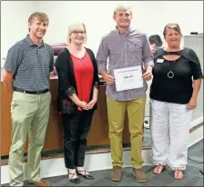  ?? kevin Myrick ?? Wrestling state champion Griffin Pace was honored by the Polk County Board of Education for his achievemen­ts at Rockmart High School, setting a wrestling win record for the Jackets during his four year career. He was joined by Coach Drew Lindsey, Board Vice Chair Kristy Gober, and Superinten­dent Laurie Atkins.