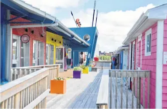  ?? DAVID JALA • CAPE BRETON POST ?? The top of the Big Fiddle is just visible above the Joan Harriss Cruise Pavilion on the Sydney waterfront where retail kiosks and shanties began opening as part of the reopening of the Nova Scotia economy.