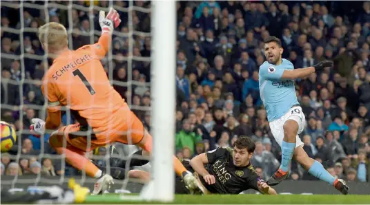  ?? — AFP ?? Manchester City’s Sergio Aguero scores in their English Premier League match against Leicester City at the Etihad Stadium in Manchester on Saturday. Man City won 5- 1.