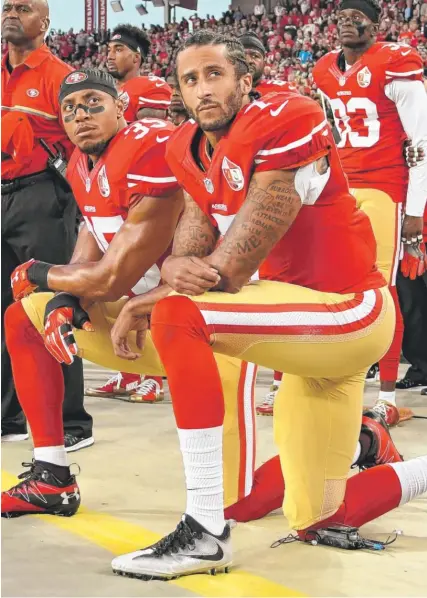  ?? | GETTY IMAGES ?? Quarterbac­k Colin Kaepernick ( foreground) started a needed conversati­on about social issues with his anthem protest.