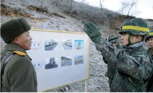  ?? — Reuters ?? Soldiers from North and South Korea verify the removal of guard posts on each side of the Demilitari­zed Zone, on Wednesday.