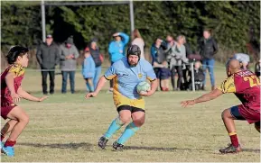  ?? GLENDA MAXWELL ?? James McKee takes the ball up in his 350th game for the Waikaia Rugby Club.