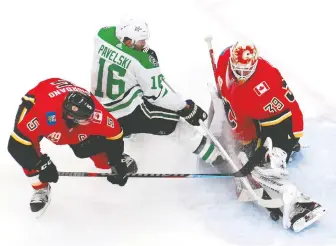  ?? JEFF VINNICK/GETTY IMAGES ?? Calgary goalie Cam Talbot stops the Stars’ Joe Pavelski during the second period of their game at Rogers Place in Edmonton on Sunday. But the veteran Dallas centre still managed a hat trick.
