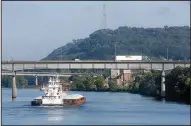  ?? NWA Democrat-Gazette/DAVID GOTTSCHALK ?? A towboat pushing six barges up the Arkansas River is visible from the Van Buren side.