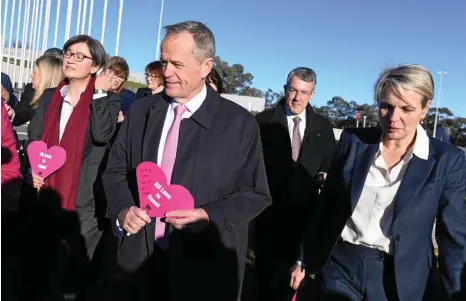  ?? PHOTO: AAP/LUKAS COCH ?? ON THE MARCH: Opposition Leader Bill Shorten (centre) holds a paper heart during the Sea of Hearts event supporting marriage equality outside Parliament House yesterday.