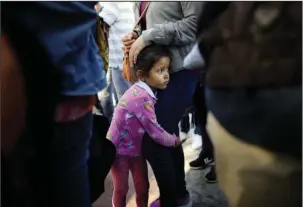  ?? The Associated Press ?? TIAJUANA: Nicole Hernandez, of the Mexican state of Guerrero, holds on to her mother as they wait with other families to request political asylum in the United States on Wednesday across the border in Tijuana, Mexico. The family has waited for about a...