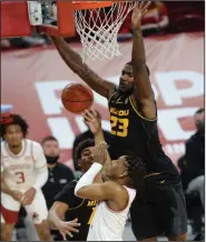  ?? (NWA Democrat-Gazette/Andy Shupe) ?? Missouri forward Jeremiah Tilmon (right) leaps to block a shot attempt by Arkansas guard JD Notae during the Tigers’ 81-68 victory over the Razorbacks on Jan. 2 at Walton Arena in Fayettevil­le. Smith scored 25 points and grabbed 11 rebounds for Missouri, which handed Arkansas its only home loss of the season. The two teams face each other today in the quarterfin­als of the SEC Tournament in Nashville, Tenn.