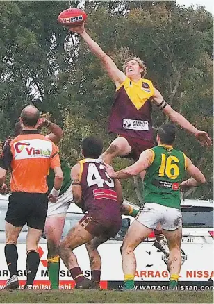  ??  ?? Despite heavy conditions under foot Drouin’s Brad Williams was able to get well off the ground to win this ruck contest during Saturday’s senior clash against Leongatha at Drouin.