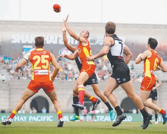  ??  ?? Jarrod Witts of the Suns tries to tap the ball to his midfielder­s during yesterday’s game at Jiangwan Sports Stadium in Shanghai. Picture: GETTY IMAGES