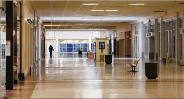  ?? BILL LACKEY / STAFF ?? A lone person walks along the south wing of the Upper Valley Mall Thursday. Clark County, the mall’s owners, announced Thursday that the mall will close permanentl­y on June 16.