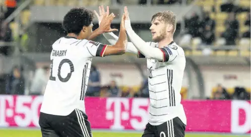  ?? AP ?? Germany’s Timo Werner (right) celebrates with teammate Serge Gnabry after scoring his side’s second goal during the World Cup 2022 Group J qualifying match against North Macedonia at National Arena Todor Proeski stadium in Skopje, North Macedonia, yesterday. Germany won 4-0.