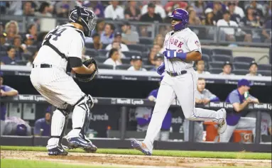  ?? Al Bello / Getty Images ?? The Mets’ Yoenis Cespedes scores a run in the fifth inning against the Yankees in front of catcher Gary Sanchez.