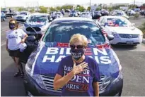  ?? CAROLYN KASTER AP ?? Supporters of former Vice President Joe Biden stand for the national anthem at a drive-in campaign event in Las Vegas.