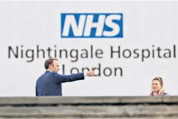  ??  ?? Thumbs up: Matt Hancock returns from self-isolation in commanding fashion, outside the newly created Nightingal­e Hospital