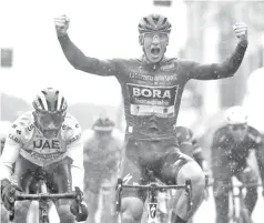  ??  ?? TeamBorari­derGermany’sPascalAck­ermann,Cyclamenje­rseyofKing­oftheGener­al Point Classifica­tion celebrates as he finishes first ahead of Team UAE Emirates rider Colombia’s Fernando Gaviria in stage five of the 102nd Giro d’Italia - Tour of Italy - cycle race, 140kms from Frascati to Terracina. - AFP photo