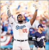  ?? KEVORK DJANSEZIAN/GETTY ?? Yasiel Puig celebrates an eighth-inning double during the Dodgers’ Game 5 victory over the Brewers on Wednesday.