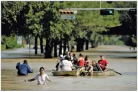  ?? CHARLIE RIEDEL/AP PHOTO ?? People evacuate a neighborho­od inundated after water was released from nearby Addicks Reservoir when it reached capacity due to Tropical Storm Harvey on Wednesday.