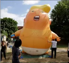  ?? AP FILE PHOTO/MATT DUNHAM ?? In this file photo taken in 2018, a six-meter high cartoon baby blimp depicting U.S. President Donald Trump in north London.