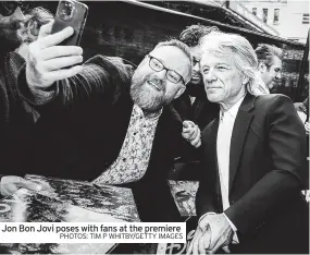  ?? PHOTOS: TIM P WHITBY/GETTY IMAGES ?? Jon Bon Jovi poses with fans at the premiere