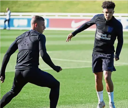  ?? — AFP ?? Independen­t: England midfielder­s Jadon Sancho (right) and Ross Barkley attending an open training session at St George’s Park in Burton-on-Trent, central England, on Tuesday ahead of their UEFA Nations League match against Croatia today.