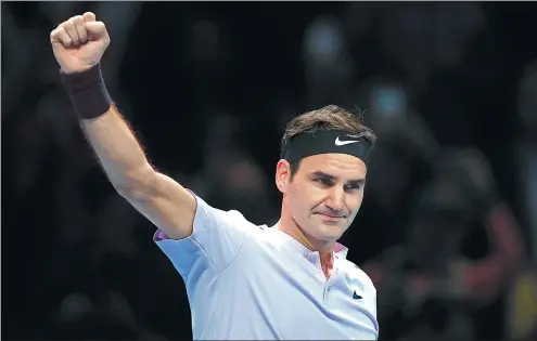  ?? KIRSTY WIGGLESWOR­TH / AP ?? Roger Federer celebrates match point after beating Jack Sock in their ATP World Finals match at the O2 Arena in London on Sunday.
