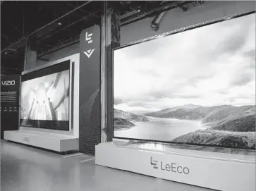  ?? Dan Steinberg Associated Press Images for LeEco ?? A VIZIO TELEVISION, left, and a LeEco Smart TV are displayed at a July 26 news conference in Hollywood at which it was announced that the Irvine company had agreed to sell itself to the Chinese firm for $2 billion.